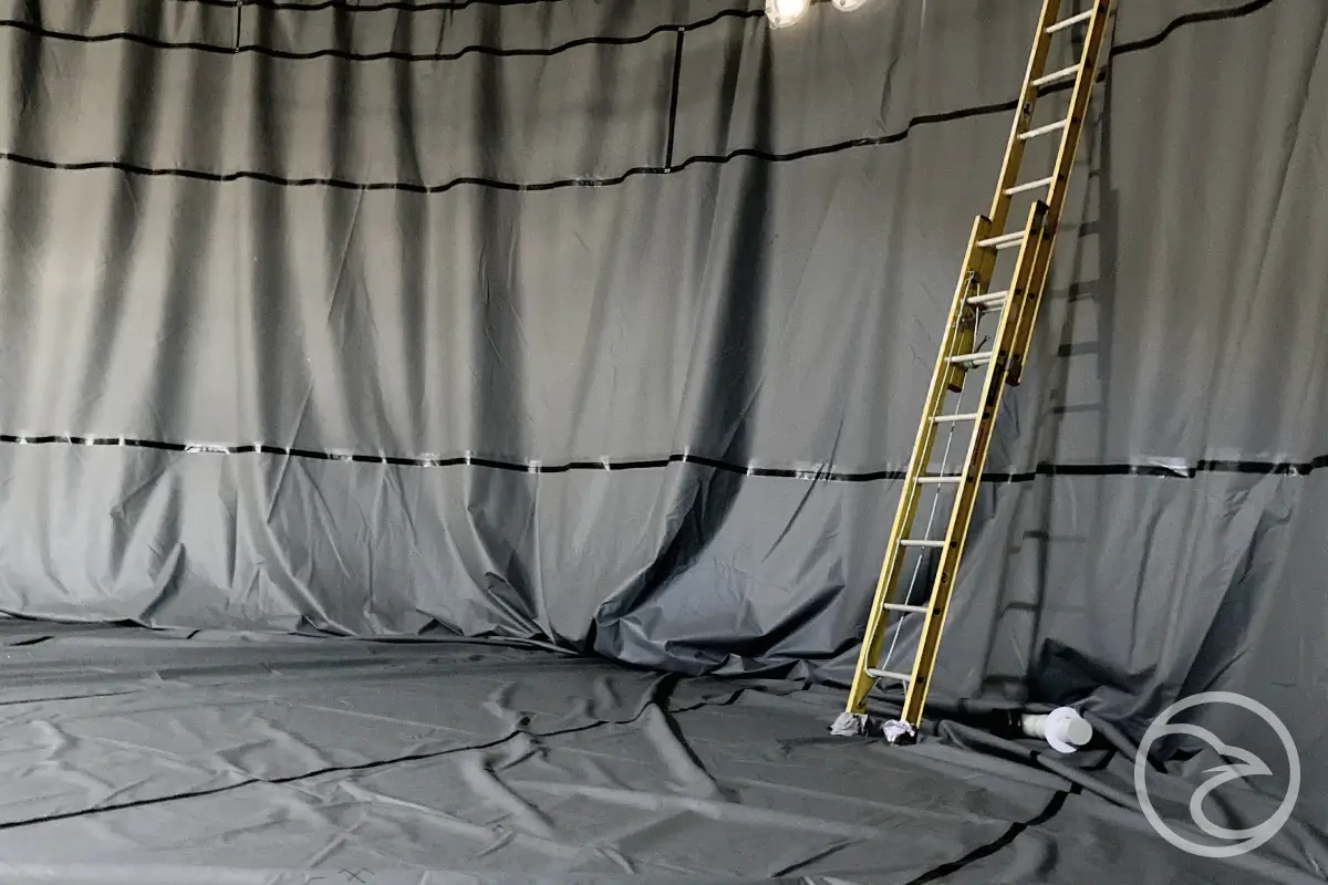 Durable containment liner protecting steel tank from corrosion