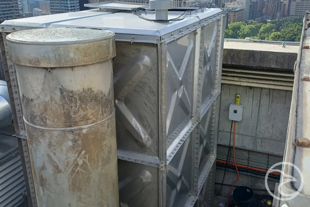 traditional steel water storage tank installed on prepared foundation