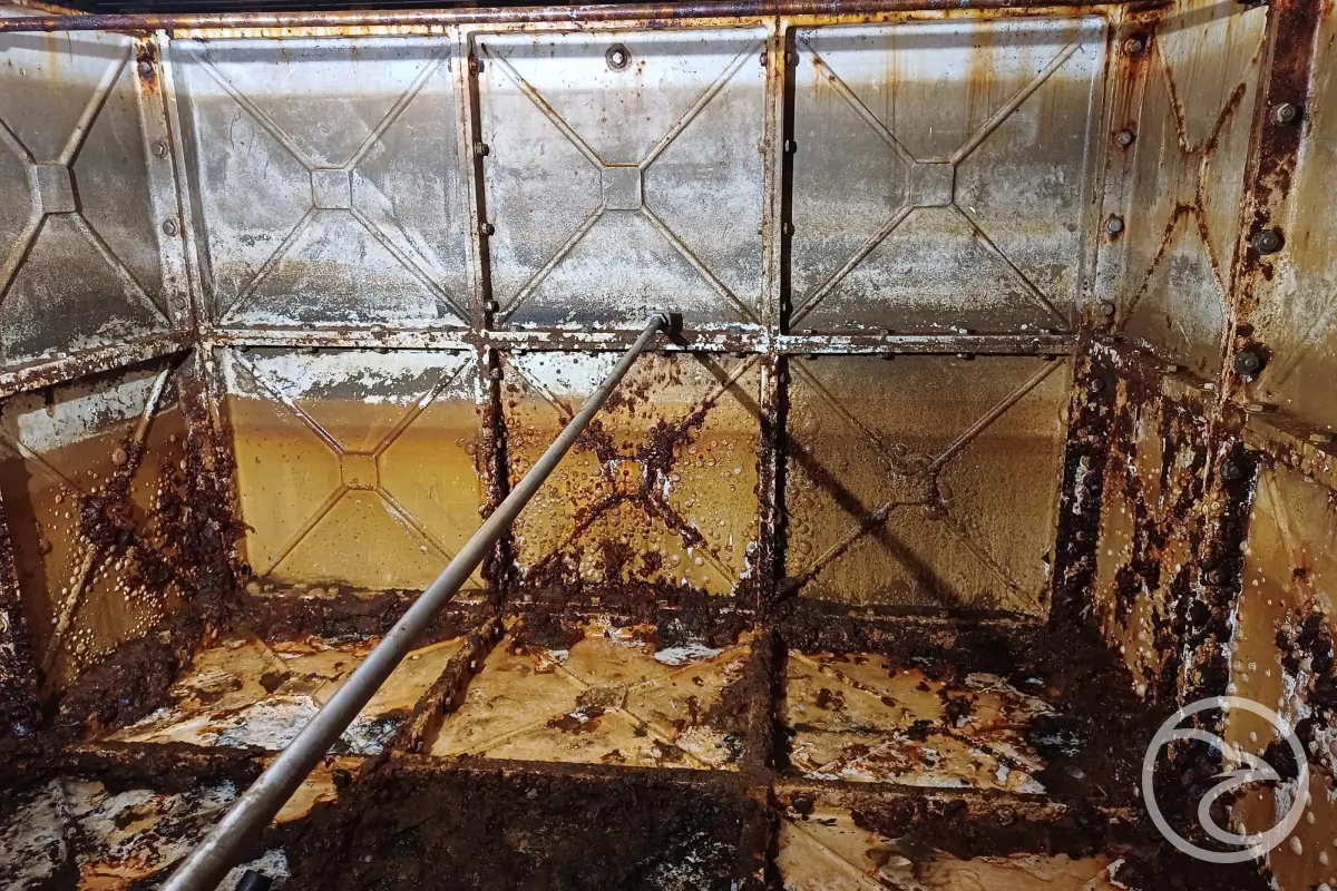 Sediment buildup contributing to tank corrosion
